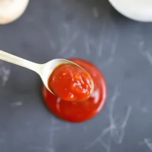 "Homemade Mark’s Sweet Pizza Sauce in a jar, ready for storage."